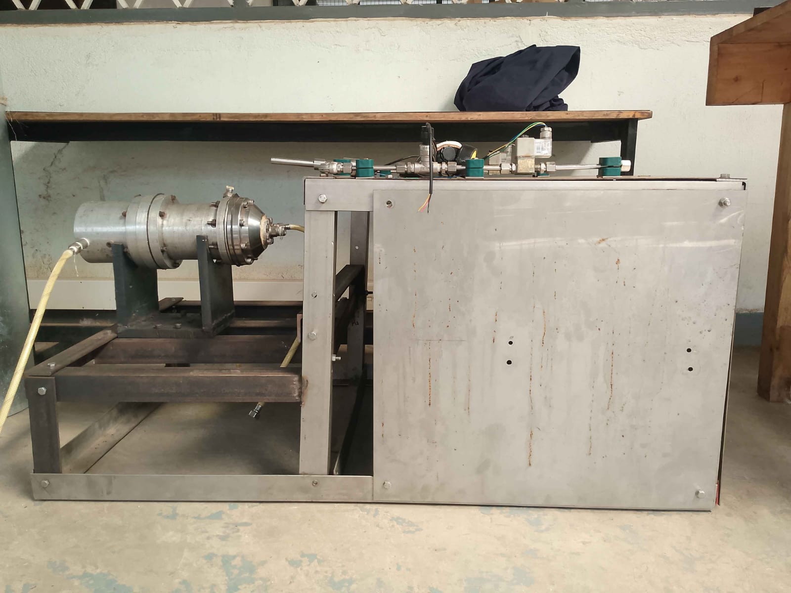 Liquid rocket engine test stand showing combustion chamber and instrumentation enclosure