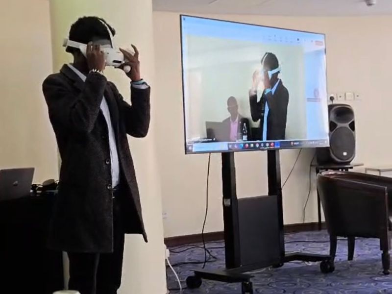 Trainee using a VR headset with the industrial training scene mirrored on screen